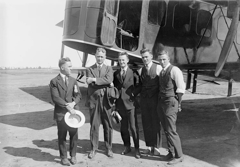 Alfred Lawson (second from left) and others standing in front of his first airliner
