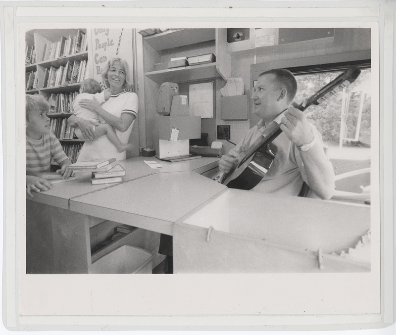 Library staff strumming guitar